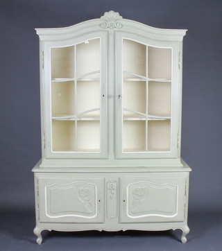 A green painted French arch shaped display cabinet with carved shell decoration, fitted shelves enclosed by astragal glazed panelled doors, the base enclosed by panelled doors raised on cabriole supports 188cm h x 124cm w x 42cm d  