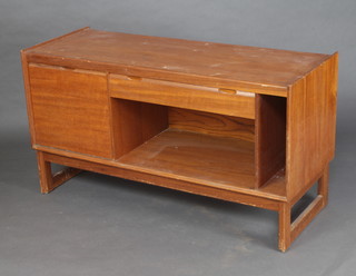 Turnidge, a 1950's teak cabinet with fall front, drawer to side above a recess, raised on square supports 67cm x 122cm x 48cm 