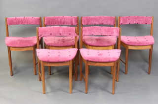 A set of 6 teak framed bar back dining chairs with upholstered seats and backs, raised on turned supports   
