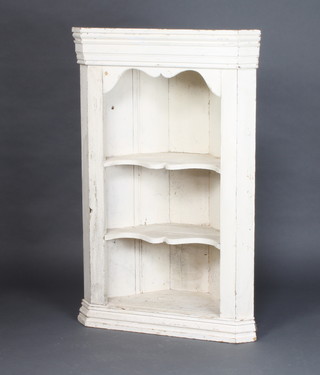 A white painted pine hanging corner cabinet, fitted shaped shelves and moulded cornice 105cm h x 68cm w x 32cm d 
