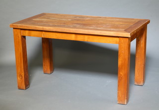 A rectangular oak dining table raised on square supports 76cm h x 80cm x 104cm