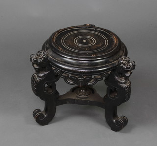 A 19th Century Chinese circular ebonised urn stand raised on Dog of Fo supports 33cm h x 36cm  
