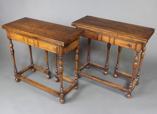 A pair of 17th Century style oak tea tables, fitted a frieze drawer, raised on turned and block supports with bun feet, 71cm h x 80cm w x 35cm d 