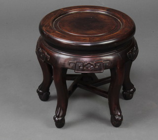 A circular Chinese carved hardwood jardiniere stand raised on cabriole supports with shaped stretcher 32cm h x 31cm diam. 