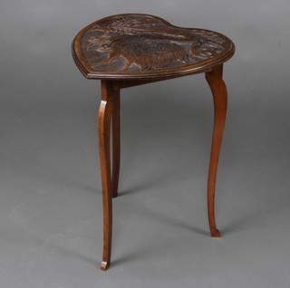 A Victorian carved oak aesthetic movement heart shaped occasional table decorated a stork 56cm x 39cm x 43cm 