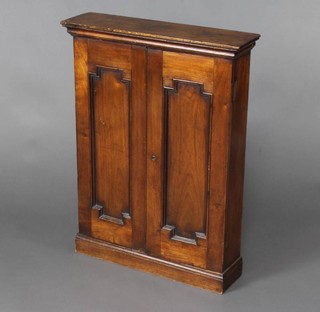 A Victorian cedar cigar cabinet with moulded cornice, enclosed by panelled doors, 80cm x 59cm x 16cm 