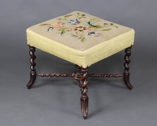 A Victorian mahogany square footstool with Berlin woolwork seat raised on cabriole supports with bobbin turned X framed stretcher 46cm x 52cm x 49cm 