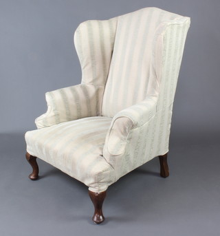 A Georgian style winged armchair upholstered in green striped material, raised on cabriole supports 