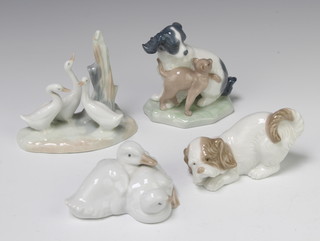 A Nao figure of a dog and kitten 11cm, a ditto of geese 6cm, a puppy 5cm and geese beside a tree trunk 10cm 
