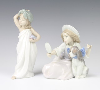 A Lladro figure of a girl with puppy looking into a hand mirror 5468 15cm (missing an accessory) together with a Lladro figure of a young girl wearing a towel holding an atomiser 6799 18cm