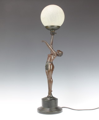 An Art Nouveau style bronzed table lamp in the form of a standing semi naked lady supporting a frosted globe 66cm x 15cm 