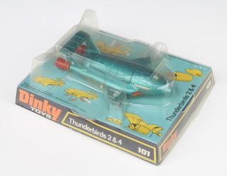 A Dinky 101 Thunderbirds II and IV model in turquoise green, boxed.
