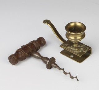 A 19th Century steel and wooden corkscrew together with a brass chamber stick incorporating a matchbox 
