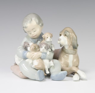 A Lladro group of a young boy with a hound and puppies no.5456 13cm 