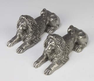 A pair of silvered figures of reclining lions 7cm x 13cm x 5cm 