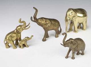 A brass figure of a standing elephant 4cm x 11cm x 2cm and 3 other brass figures of elephants 