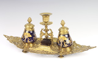 A Victorian pierced gilt metal boat shaped ink stand with candle sconce, brush wipe and 2 inkwells raised on bun feet 14cm x 42cm x 18cm 