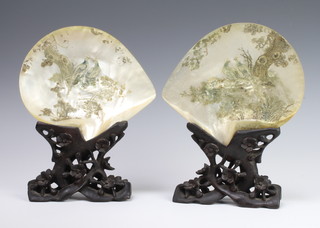 Two Chinese carved mother of pearl shells decorated birds, raised on carved and pierced stands 23cm x 18cm 