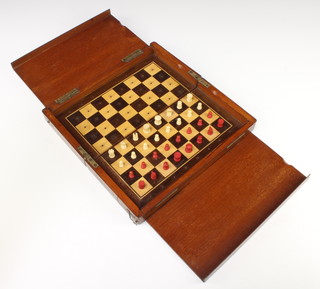A Victorian red and white ivory travelling chess set contained in a mahogany folding box