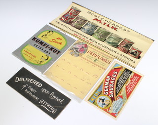 A rectangular poster for The Dutch Condensed Milk Company 21cm x 49cm (slight damage to the top), metal sign for Kumfi-Kut Scissor 24cm x 19cm, a card wall mounting display for Perfumes True to Nature 25cm x 20cm, a card sign Delivered Upon Payment of First Instalment Attwells 10cm x 26cm, ditto Real German Sausages 14cm x 23cm 