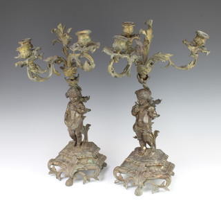 A pair of 19th Century 3 light Rococo style bronze candelabrum supported by figures of cherubs with birds, raised on shaped bases 50cm x 30cm 