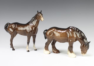 A Beswick figure of a grazing shire horse 1050, brown gloss by Arthur Gredington 14cm and a ditto Swish tail horse 1182, brown gloss, by Arthur Gredington 22.2cm 
