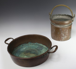 An Eastern copper pail with brass swing handle 24cm x 26cm and a copper twin handled preserving pan 11cm x 51cm 
