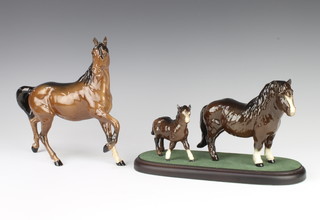A Beswick group Shetland Pony no.1033 and foal no. 1034 in brown gloss by Arthur Gredington 14.6cm and 9.5cm,  together with a ditto Spirit of the Wind no.2688 in black brown gloss by Graham Tongue 20.3cm 