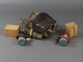 A child's Second World War Mickey Mouse respirator and box, a civilian respirator and a babies ditto 