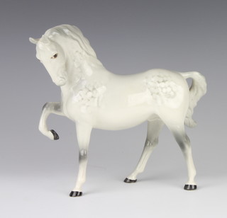 A Beswick figure of a horse (head tucked, leg up) in rocking horse grey no.1549 by Pal Zalmen 19.1cm 