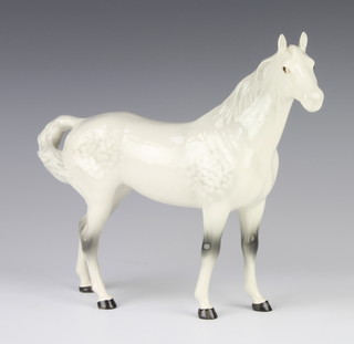 A Beswick figure of a swish tail horse no.1182, in rocking horse grey gloss by Arthur Gredington 22.2cm  