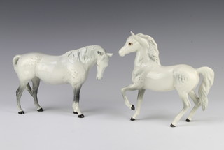 A Beswick figure of a horse (prancing Arab type), in rocking horse grey, no.1261 17.2cm together with a ditto mare (facing right, head down) grey, no.1812, 14.6cm, both by Arthur Gredington  