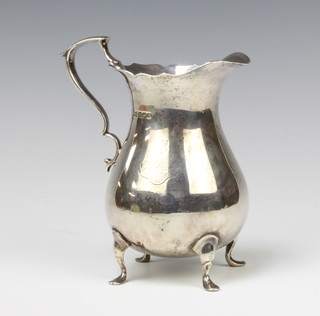 A Georgian design silver milk jug with S scroll handle on pad feet, Sheffield 1922, 286 grams