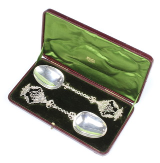 A pair of 19th Century Dutch silver serving spoons, the pierced handles with galleons, 132 grams, in original fitted case   
