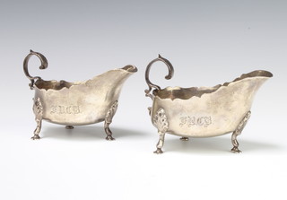 A pair of Victorian silver sauce boats with cut rims and S scroll handle on pad feet, Birmingham 1897, 378 grams