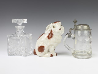 A Continental clear glass tankard with pewter mounts 20cm, a square decanter and stopper 20cm and a Chinese figure of a rabbit 19cm 