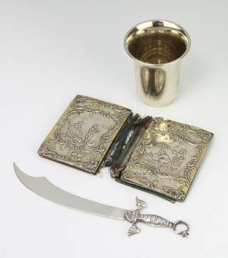 A Continental silver mounted purse decorated with figures in a garden landscape, a paper knife and a beaker 
