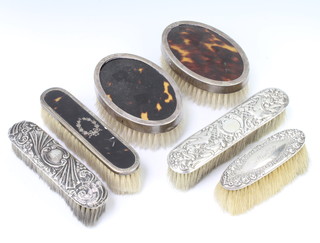 A pair of silver and tortoiseshell hair brushes, 4 clothes brushes