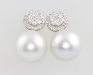 A pair of 18ct white gold South Seas pearl and brilliant cut diamond earrings, approx. 1ct 22mm 
