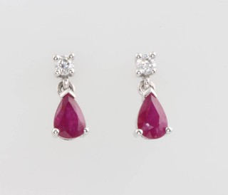 A pair of white gold pear cut ruby and diamond ear studs 10mm