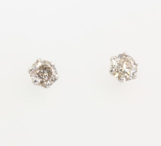 A pair of platinum single stone diamond ear studs, each approx. 0.15ct 