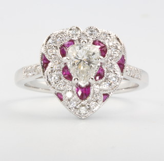An 18ct white gold Victorian style heart shaped diamond and ruby ring with central pearl cut diamond approx. 0.58ct, size N 