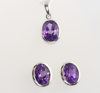 A pair of 9ct white gold oval amethyst ear studs and matching pendant 10mm 