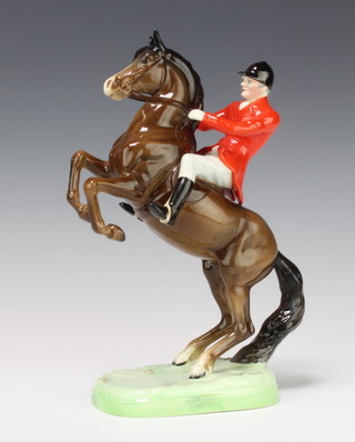A Beswick figure of a huntsman on a rearing horse with red coat and brown gloss by Arthur Gredington no.868  25.4cm 