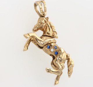 A 9ct yellow gold articulated horse pendant 10.9 grams 