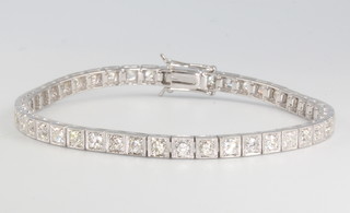 A 14ct white gold brilliant cut diamond line bracelet approx 4ct. 19cm 
