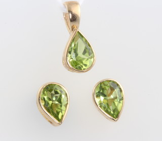 A yellow gold pear cut peridot pendant and ensuite ear studs 7mm 