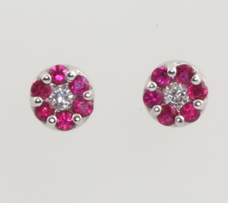 A pair of white gold circular ruby and diamond ear studs 5mm 