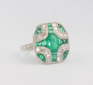 A platinum Art Deco style emerald and diamond cocktail ring, emeralds approx. 2.98ct, brilliant cut diamonds 0.59ct, size N 