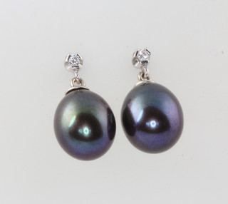 A pair of cultured black pearl and diamond earrings 